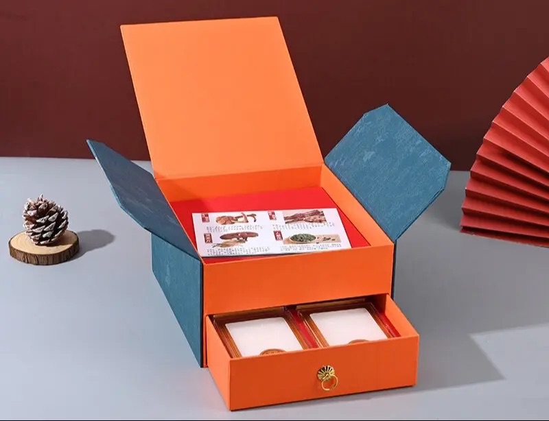 Orange gift box with side panels and a lower drawer